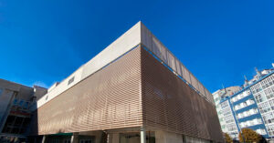 Fachada hospitalaria con revestimiento técnico sostenible VISENDUM® en listones, solución sin PVC para arquitectura saludable.